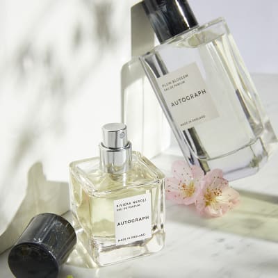 Two bottles of Autograph women’s perfume with pink blossom. Shop women’s perfume