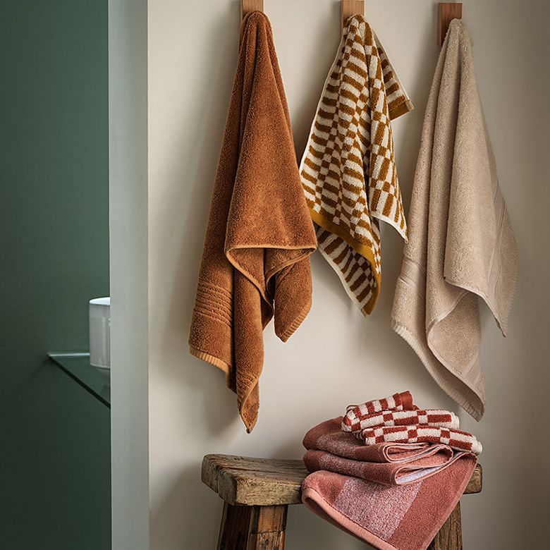 Stacks of neutral and patterned towels. Shop towels 